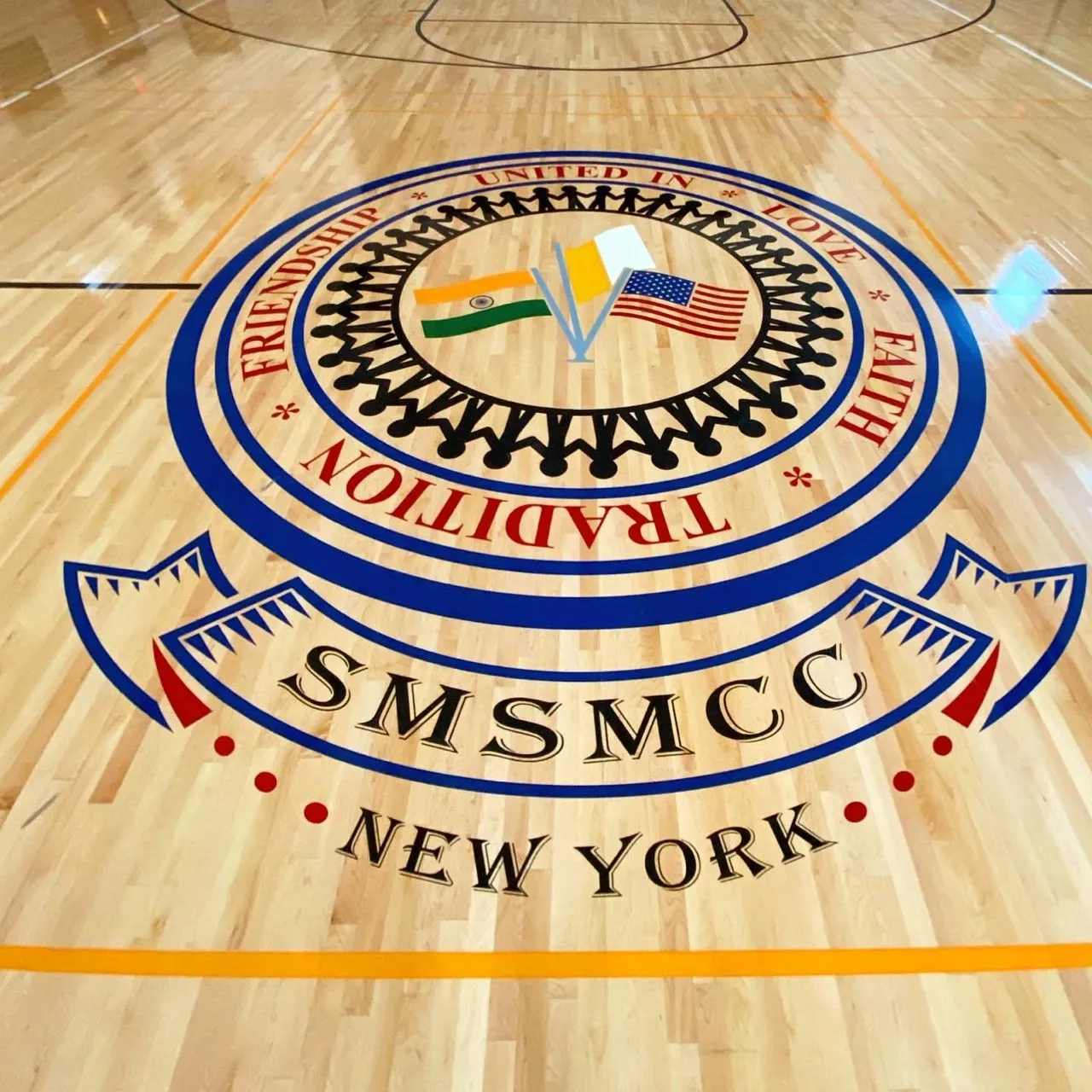 SMSMCC New York crest painted at center court on a maple gym floor