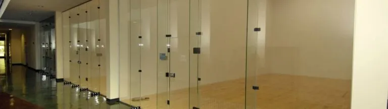 Row of racquetball courts with maple floors and glass walls
