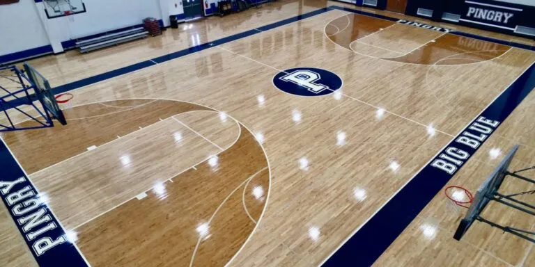 Pingry School gym with a refinished maple floor, navy border and BIG BLUE lettering
