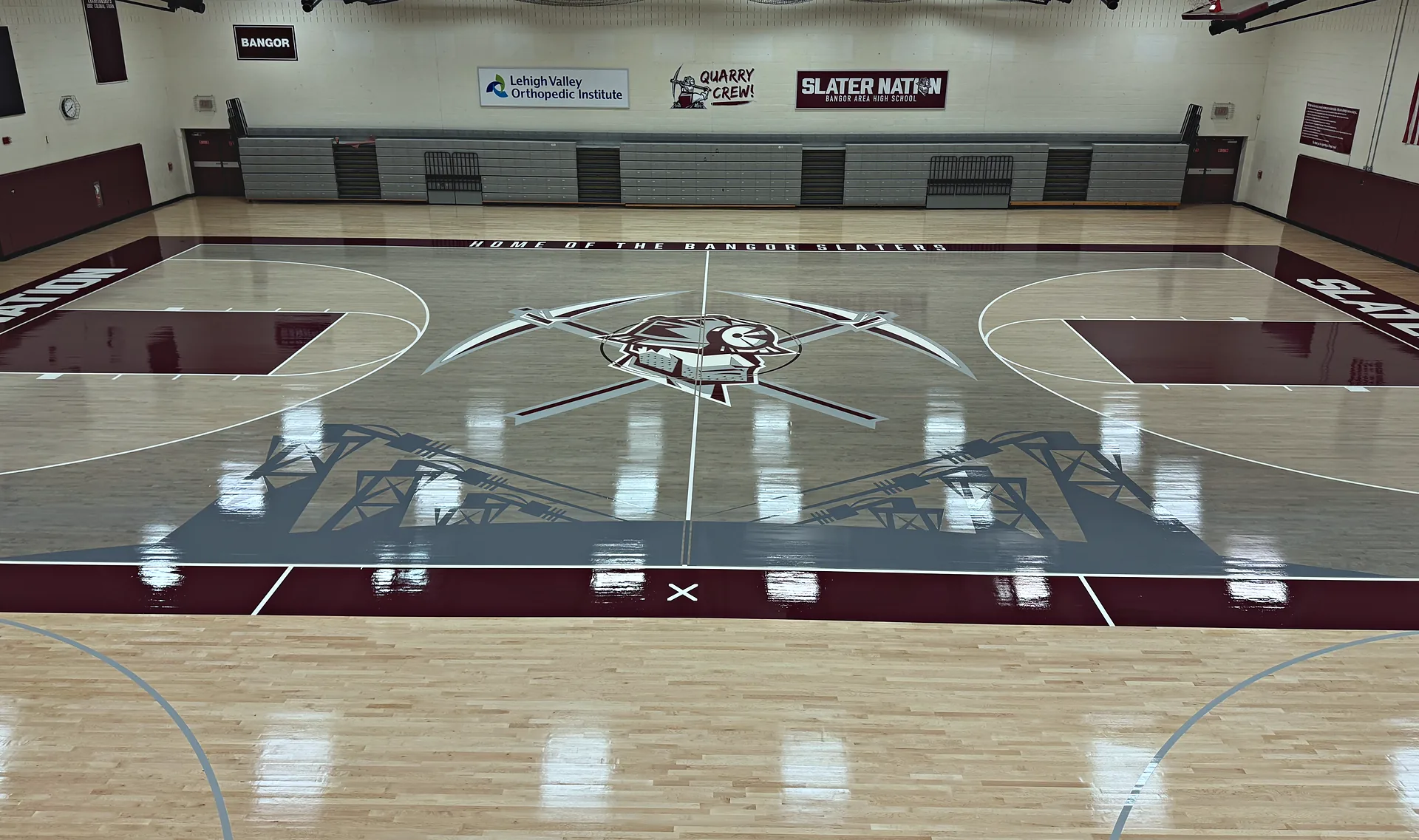 Bangor Area High School Slaters gym with a new maple floor, gray stained keys, maroon border and center logo