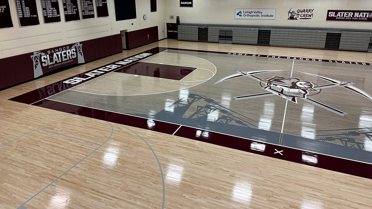 Bangor Area High School Slaters gym floor with gray stained key, center logo and maroon border