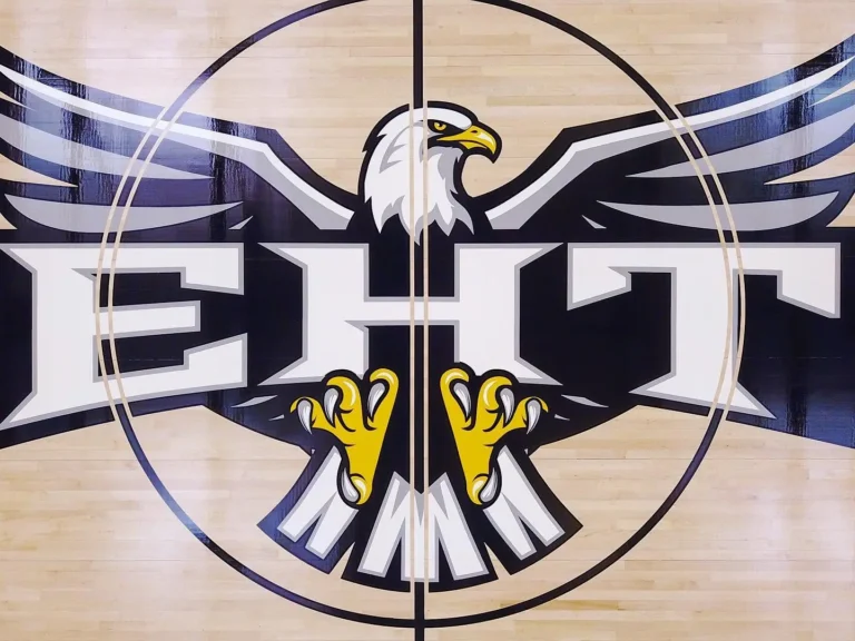 Close-up of the EHT eagle center court logo painted on a maple gym floor