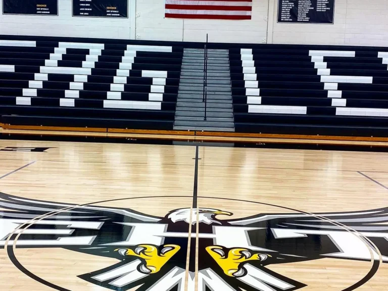 EHT Eagles center court logo on a high-gloss maple gym floor, seen from the lane
