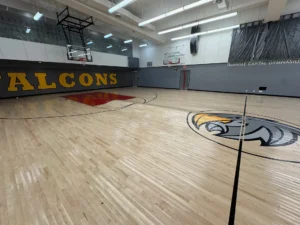 Before: the Falcons gym with its old floor, which had a large hump
