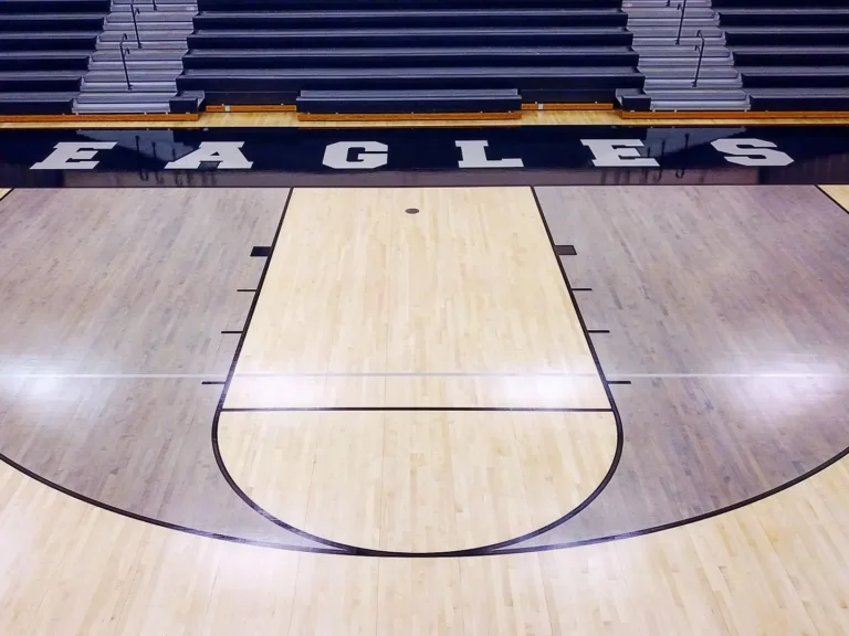 Glossy maple gym floor key and game lines with EAGLES sideline lettering