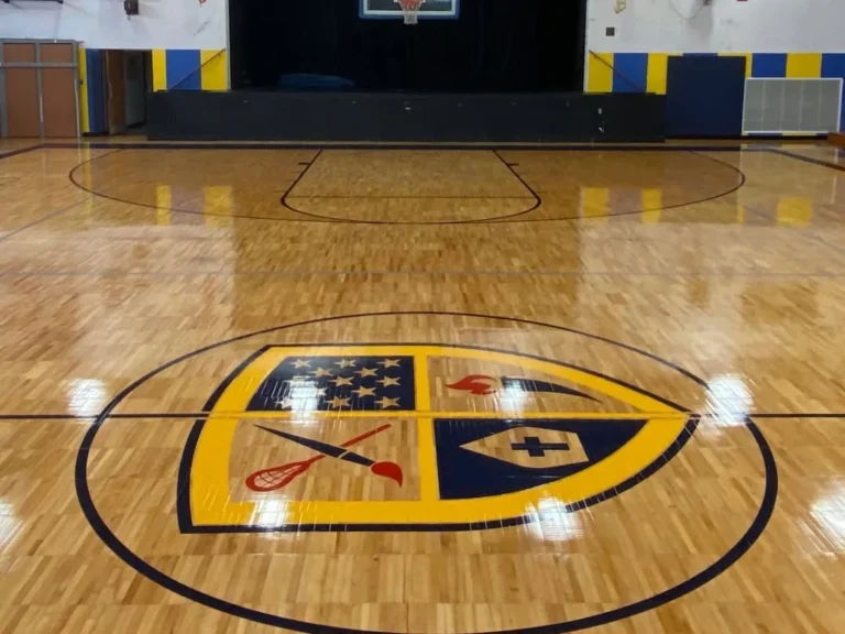 After: Greenwich Catholic School maple gym floor sanded and refinished with new game lines and a center crest