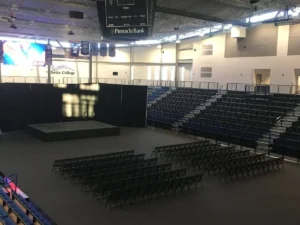 Gym floor cover tiles protecting an arena floor set up with chairs and a stage
