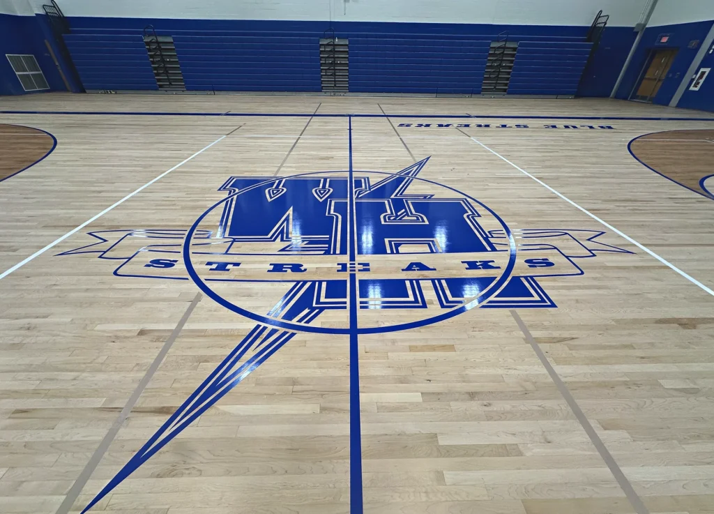 Warren Hills Regional High School Blue Streaks royal blue center-court logo painted on a refinished maple gym floor in Washington, NJ