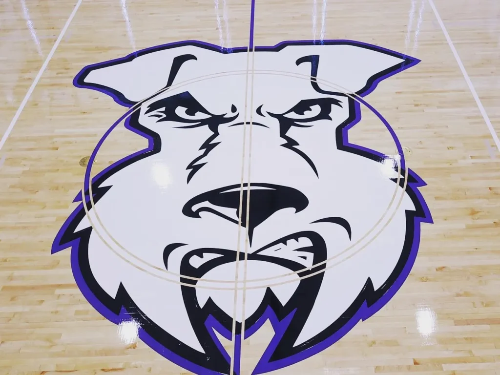 Purple and white terrier center court logo on the new maple gym floor at Newark Tech