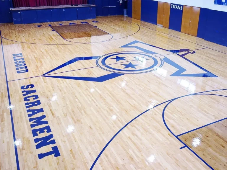 Blue SACRAMENT sideline lettering and center court logo on a glossy maple gym floor