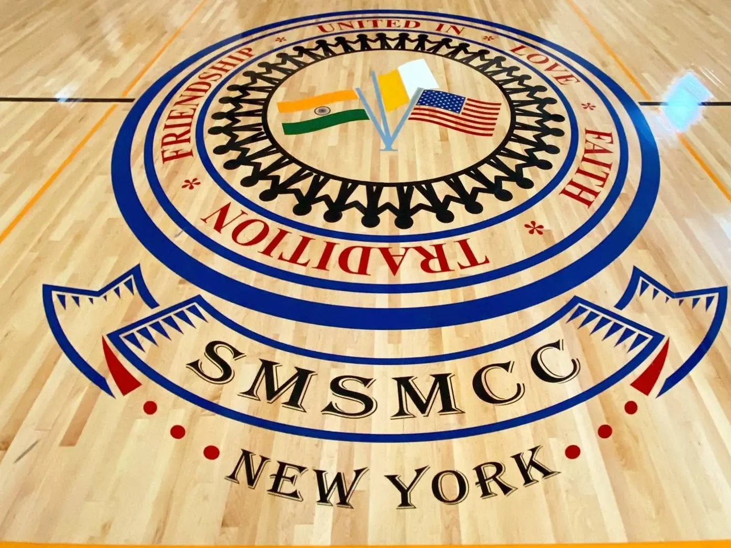 SMSMCC New York seal painted at center court on a maple gym floor