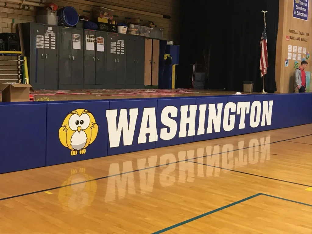 Navy custom stage pads with an owl logo and WASHINGTON lettering along the front of a stage