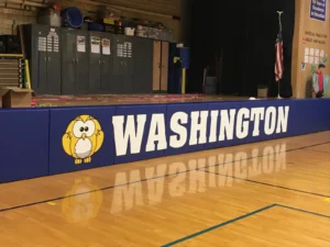 Navy custom stage pads with an owl logo and WASHINGTON lettering along the front of a stage